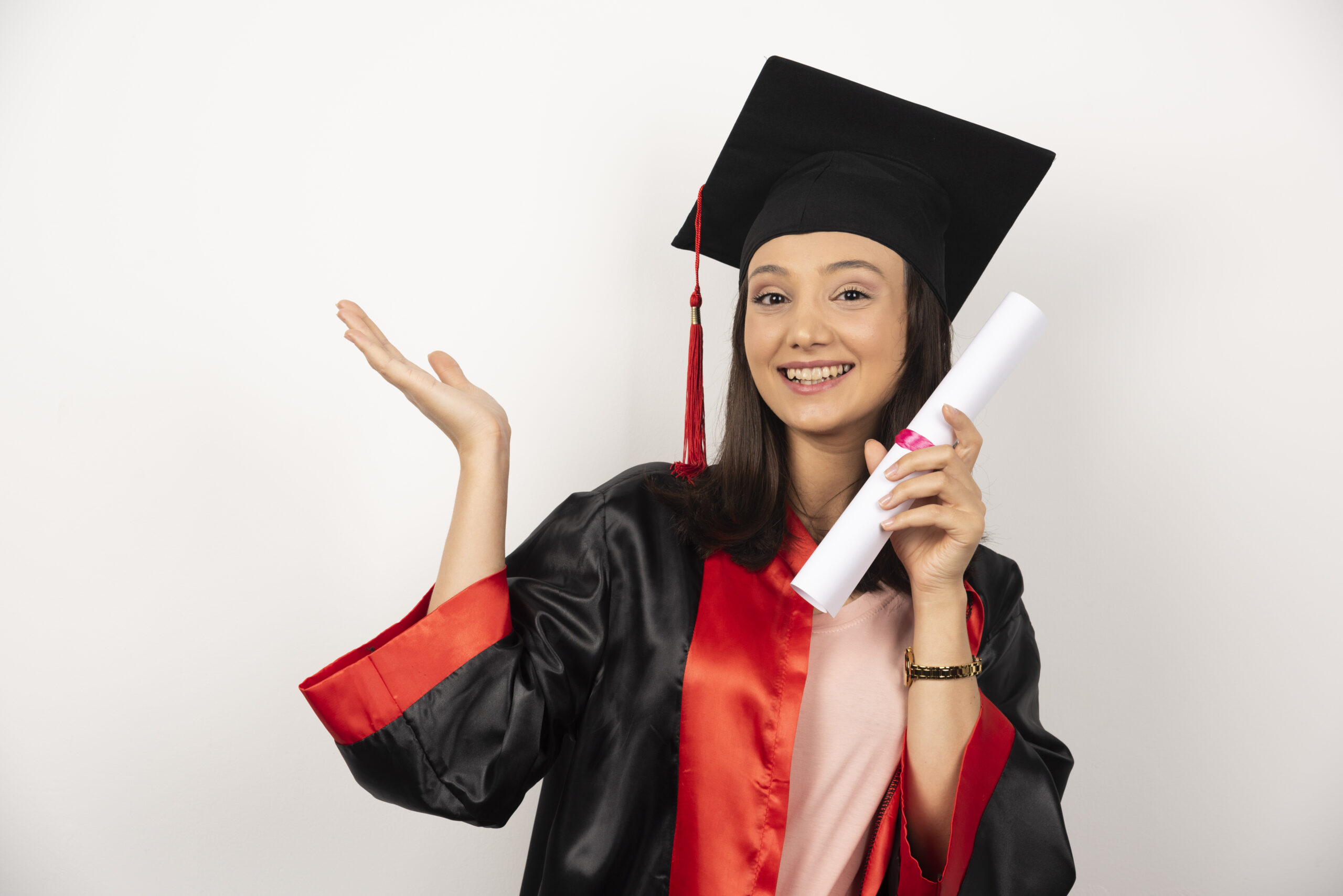 Fresh graduate female with diploma posing on white background. High quality photo